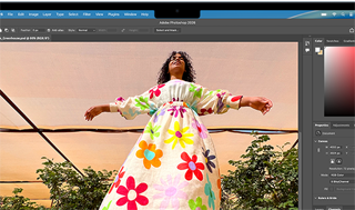 MacBook Air, screen shows an Adobe Photoshop window displaying a photo of a woman in a colorful floral dress, to showcase the brightness of the Liquid Retina display