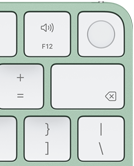 Rechterbovenhoek van Magic Keyboard in de kleur groen, Touch ID, Delete-toets en volumetoetsen