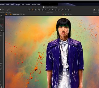 MacBook Pro screen of a photo of a person being edited in Capture One
